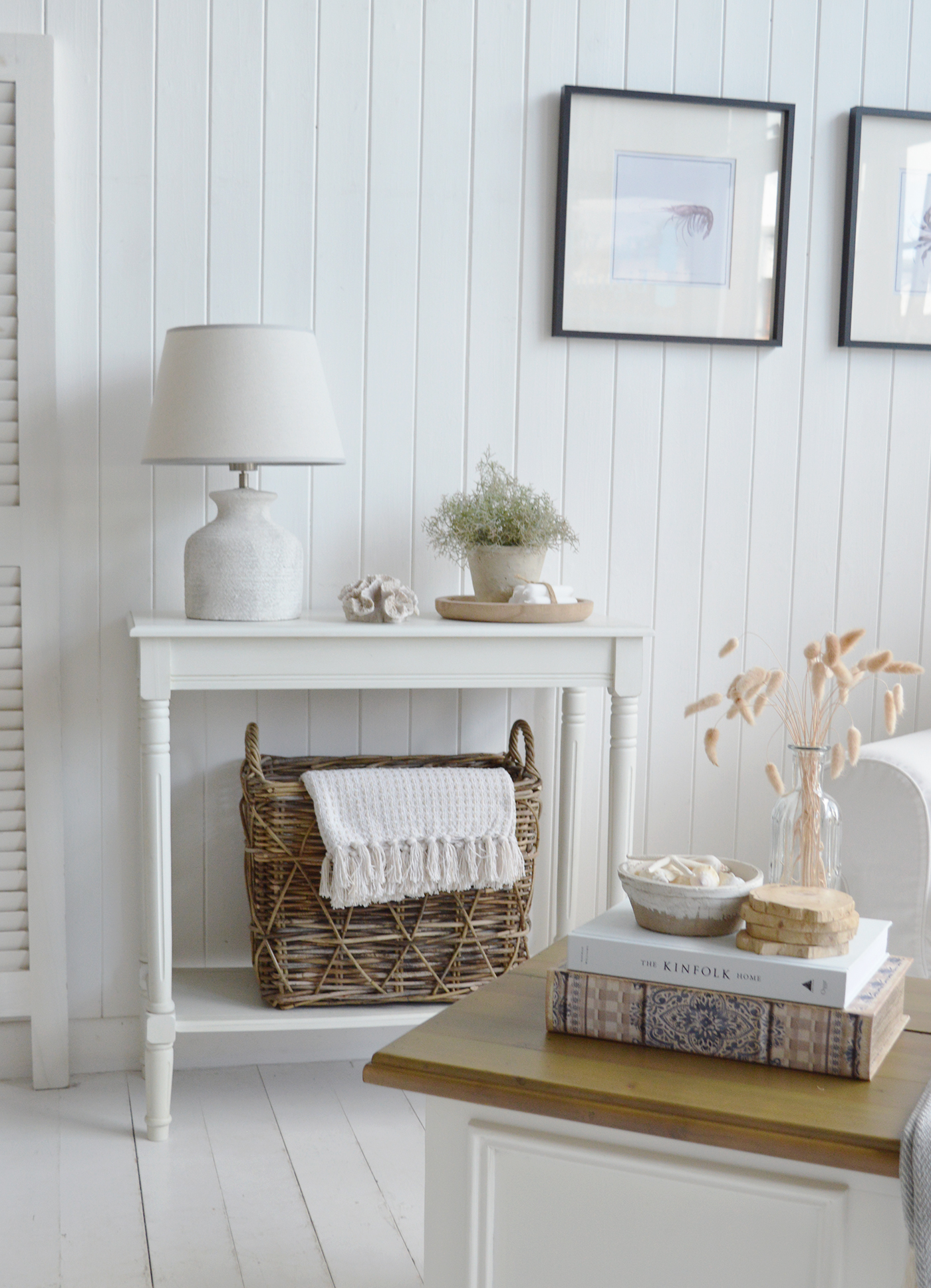 A white coastal Hamptons sttle living room in a beach house. The Cape Ann white console taking centre stage