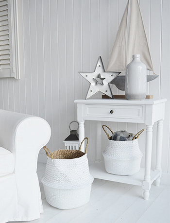Sun bleached white furniture with naturally made home baskets give such a bright coastal look