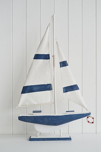 Tall decorative wooden boat in white and blue