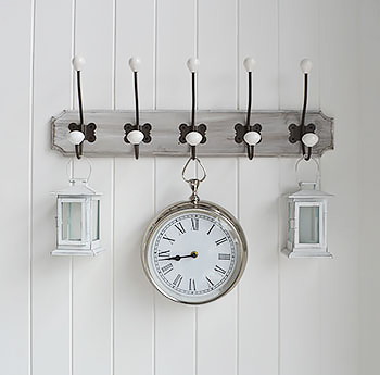 Wooden hooks with clock for wall feature.