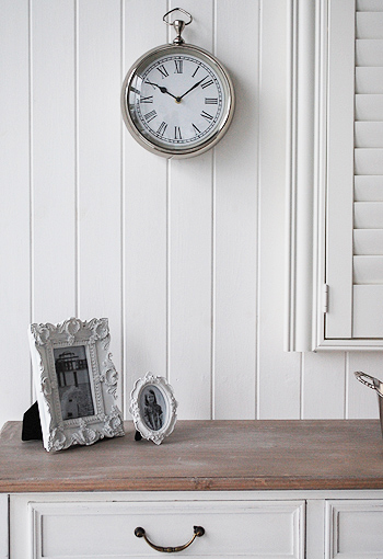 Chrome wall clock shown with the Provence Console table
