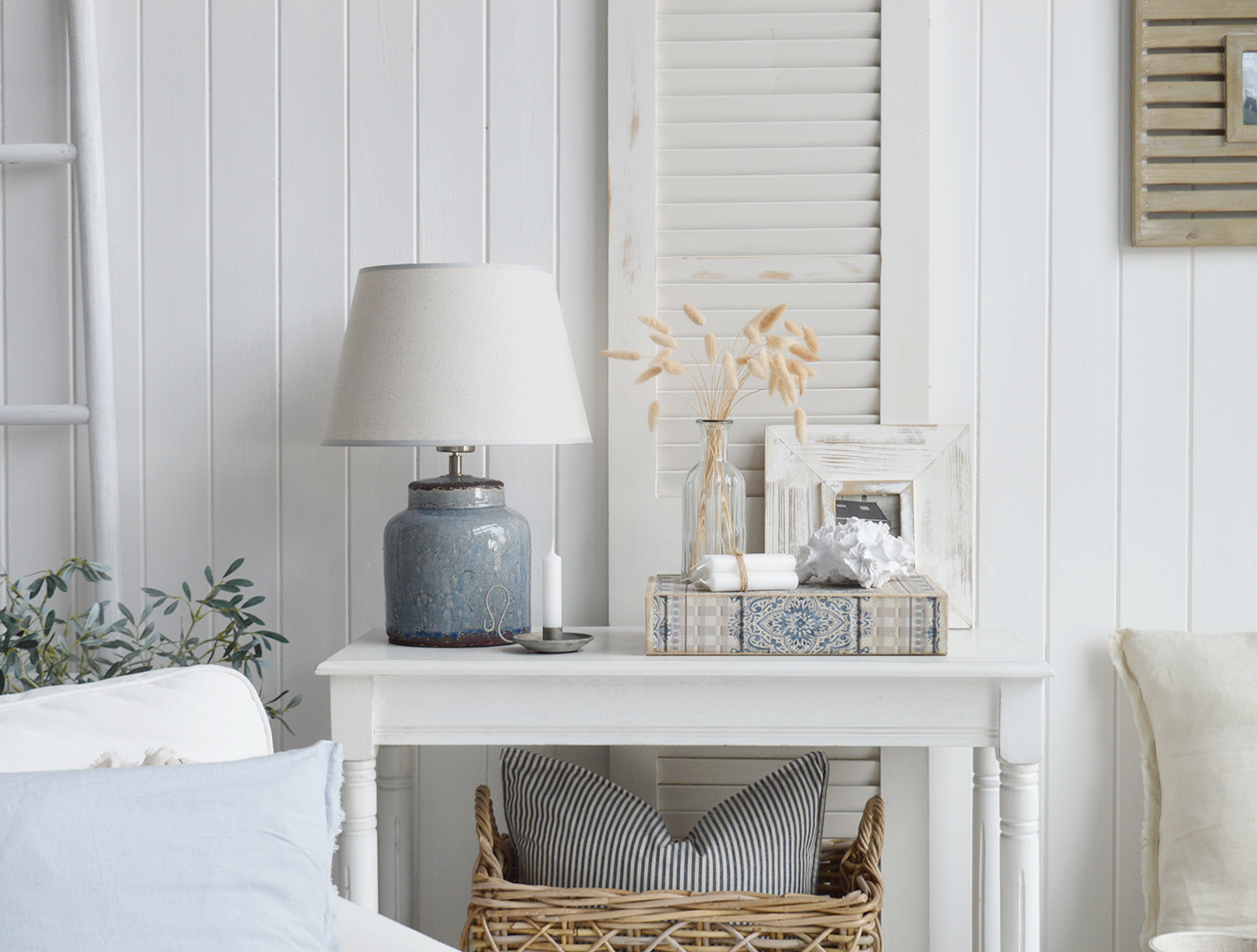 The blue grey storage book, shown in a coastal living room, perfect in a beach style home