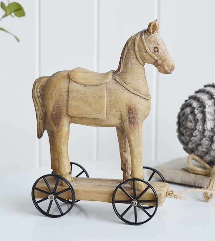 A carved wooden effect decorative horse on wheels from the White Lighhtouse New England style furniture and home interiors