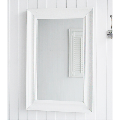 A large white wall mirror with wide frame, can be wall hung or simply rest on a table top for dressing or console table.