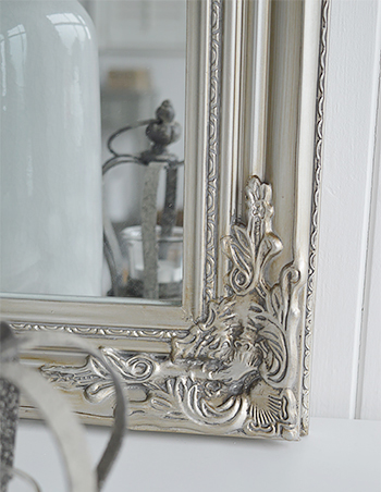Large silver wall mirror close up of frame