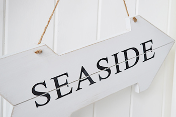 White wooden oseaside sign for coastal accessories