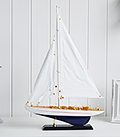 Decorative white and blue wooden yacht for homes by the sea or coastal interior styling