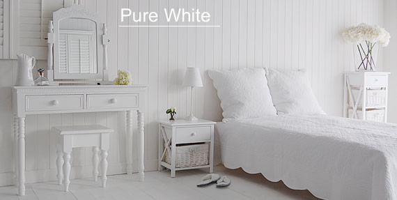 Pure white bedroom furniutre, calm in its purity and simplicity. Shows the white New England white dressing table, New Haven bedside and New Haven tall storage unit