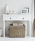 The New England narrow white console table for small hallway furniture with antique brass handles on the drawers. Suits all styles of homes from coastal to country