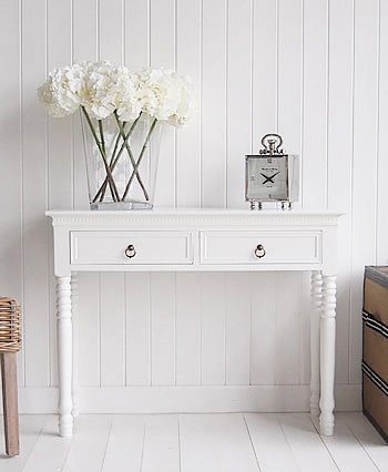 Simple white narrow hall table with drawers in a more traditional style on interior