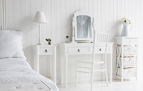 Pieces of white children bedroom furniture including a dressing table, chair and bedside table with storage