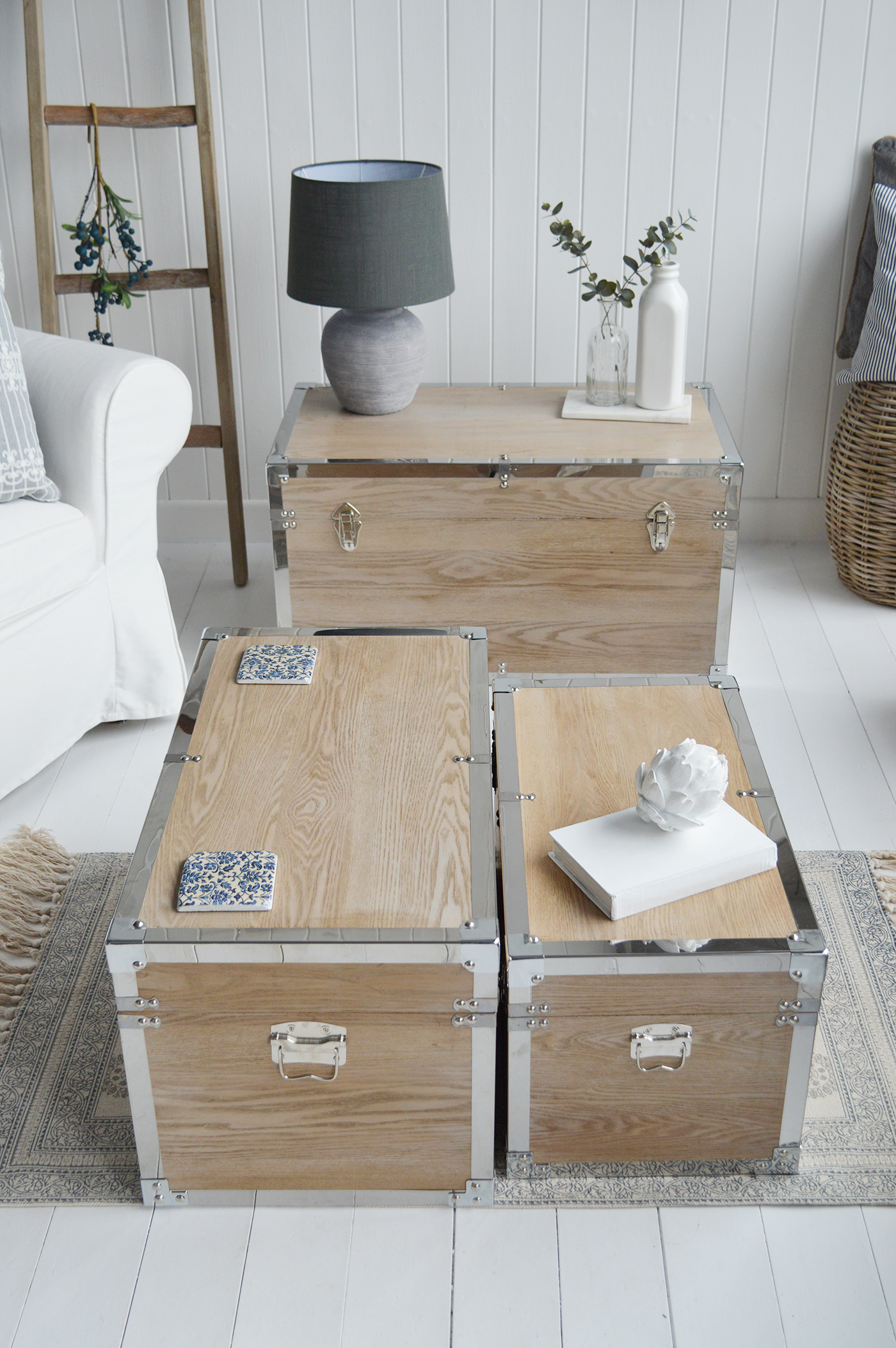 Vermont white washed storage trunks from The White Lighthouse. New England style furniture for coastal, country, farmhouse, cottage and city homes and interiors. Living Room, hallway and bedroom storage furniture