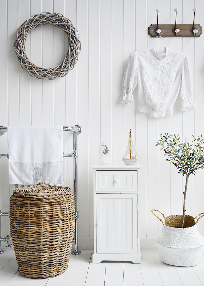 Maine white bathroom cabinet. White Furniture for storage with a cupboard and drawer. How to decorate and furnish a bathroom for homes by the sea