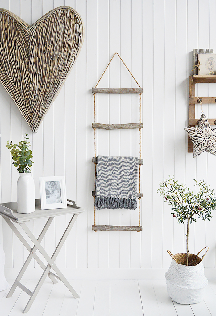 A rope ladder with driftwood effect rungs to hang towels, throws or blankets for a nautical coastal styled home interior from The White Lighthouse Furniture