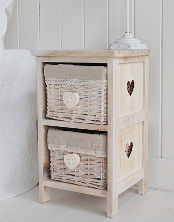 A small bedside table with two lace trimmed lined basket drawers. The hanging heart handles perfectly complement the cut out hearts on the side.

Perfect when space is at a premium in your bedroom, but you still want a table top for a lamp along with a lttle extra storage.