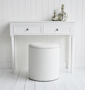 A round white dressing table stool
