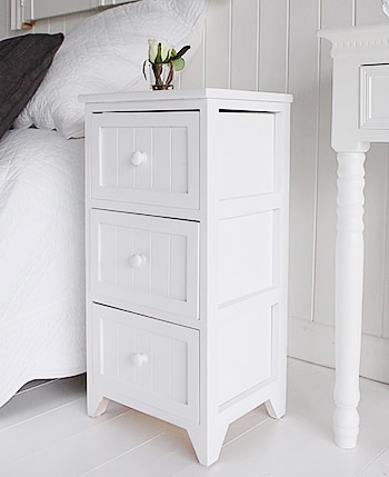 Side view of white bedside table from The Maine white bedroom furniture range