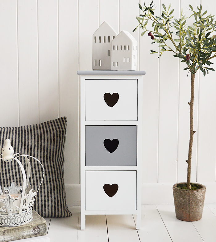 The Sweetheart narrow white bedside table in grey and white with three drawers and a cut out heart 

Ideal for when space is tight, Only 25cm at the widest
