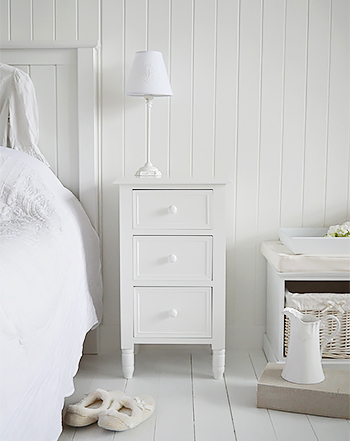A simple white New England bedside table