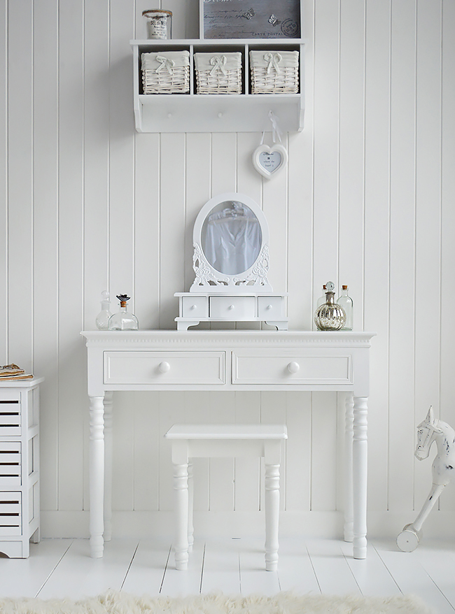 A large photo of the white dresser with drawers along with a smller trinket style mirror on the table top. Lovely accessories and perfume bottles to match