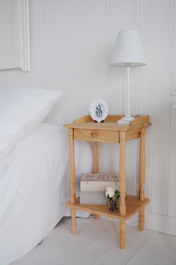 Side view of small bedside table with drawer and shelf