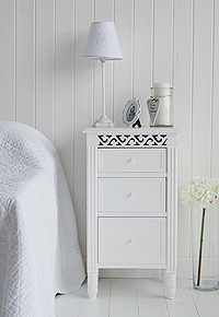 White bedside cabinet with three drawers of different depths