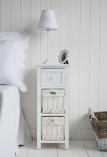 A narrow bedside table with two lined basket drawers and a wooden drawer with a knob.

Ideal for small spaces besdide a bed or extra bedroom storage

With a white satin painted finish, and the classic New England style, this makes a lovely little bedside table.