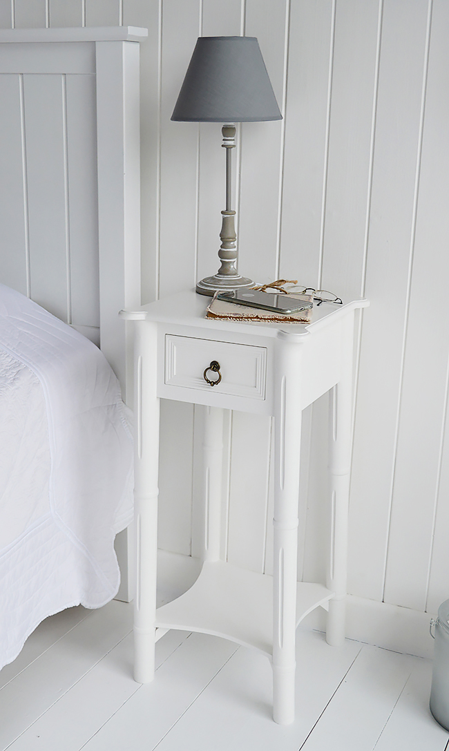 Show the top of the nightstand in white with a drawer. Perfect for a bedside lamp and to keep your phone safe