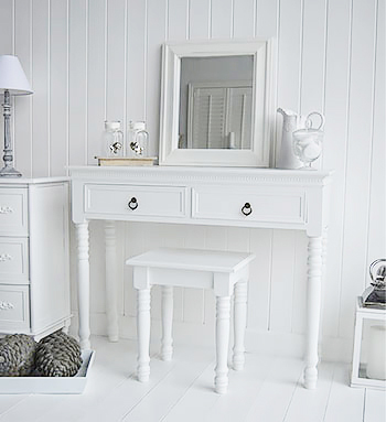 New England white vanity dresing table with a white mirror. White bedroom furniture for a white home