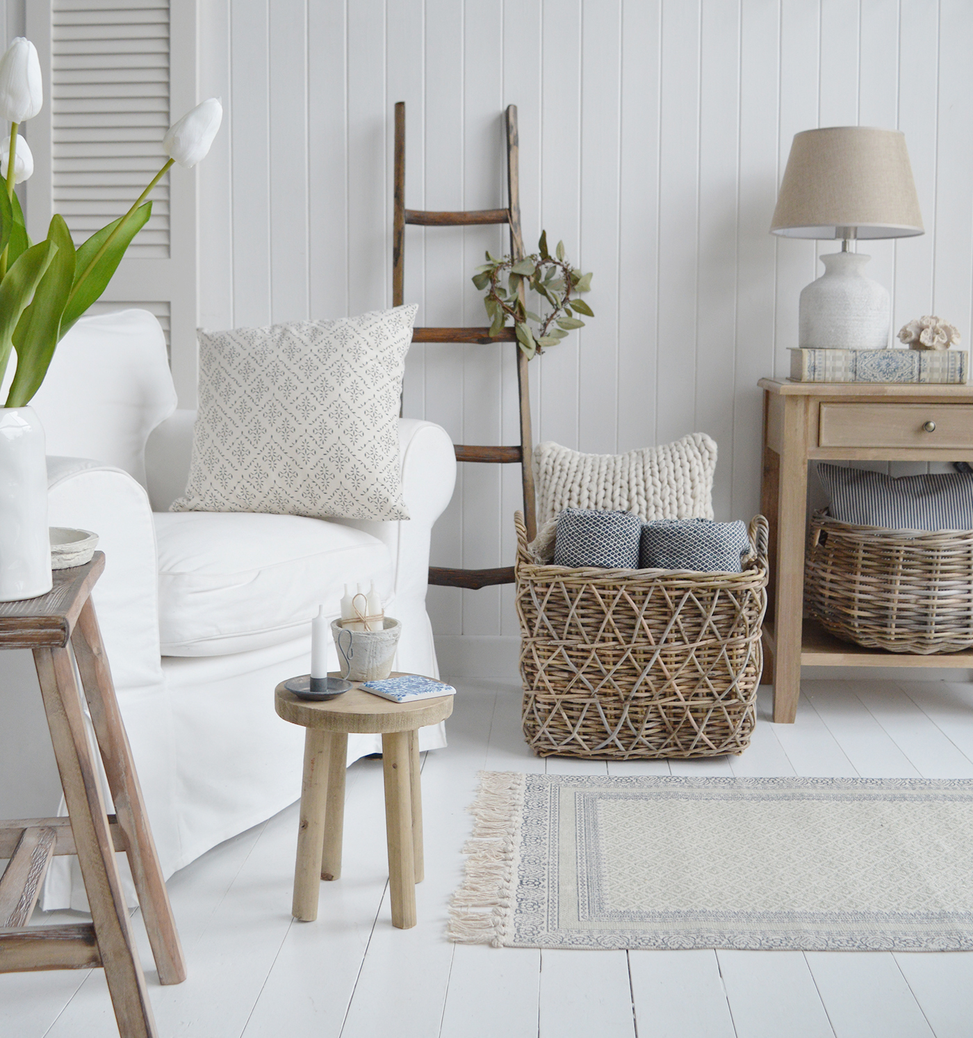 So much texture for laid back living New England style ... showing a rustic wooden blanket ladder with baskets and natural materials