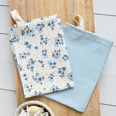 Elevate your kitchen with Piermont tea towels in sky blue stripes and floral prints. Perfect for Hamptons and New England-inspired interiors—elegant, coastal, and timeless.