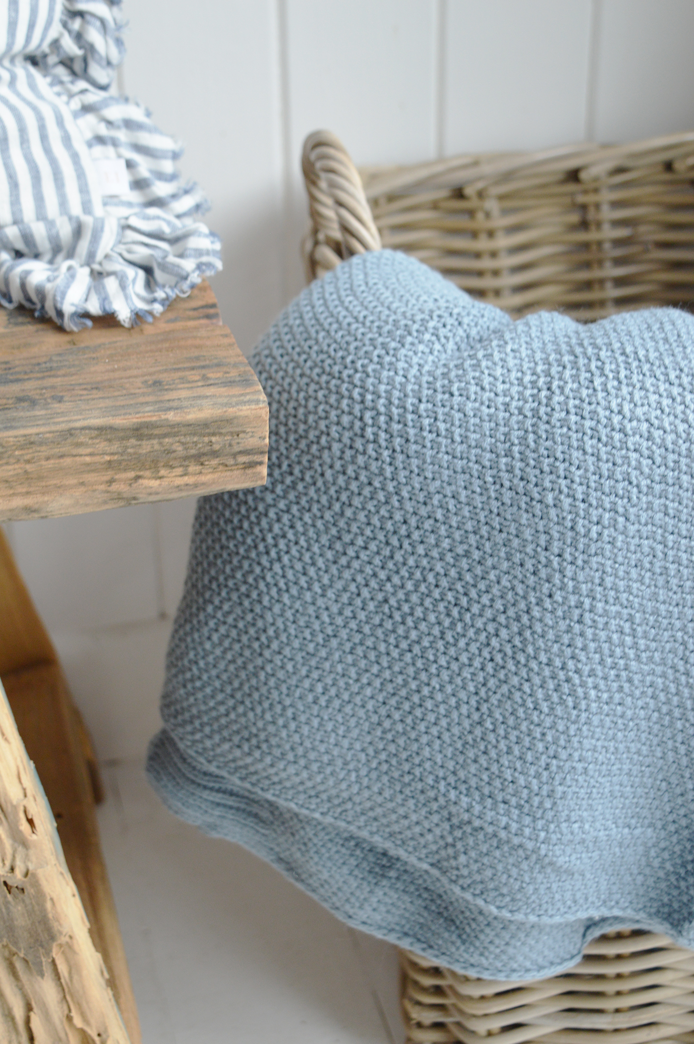 Modern coastal decor with soft blues, whites, and natural wood