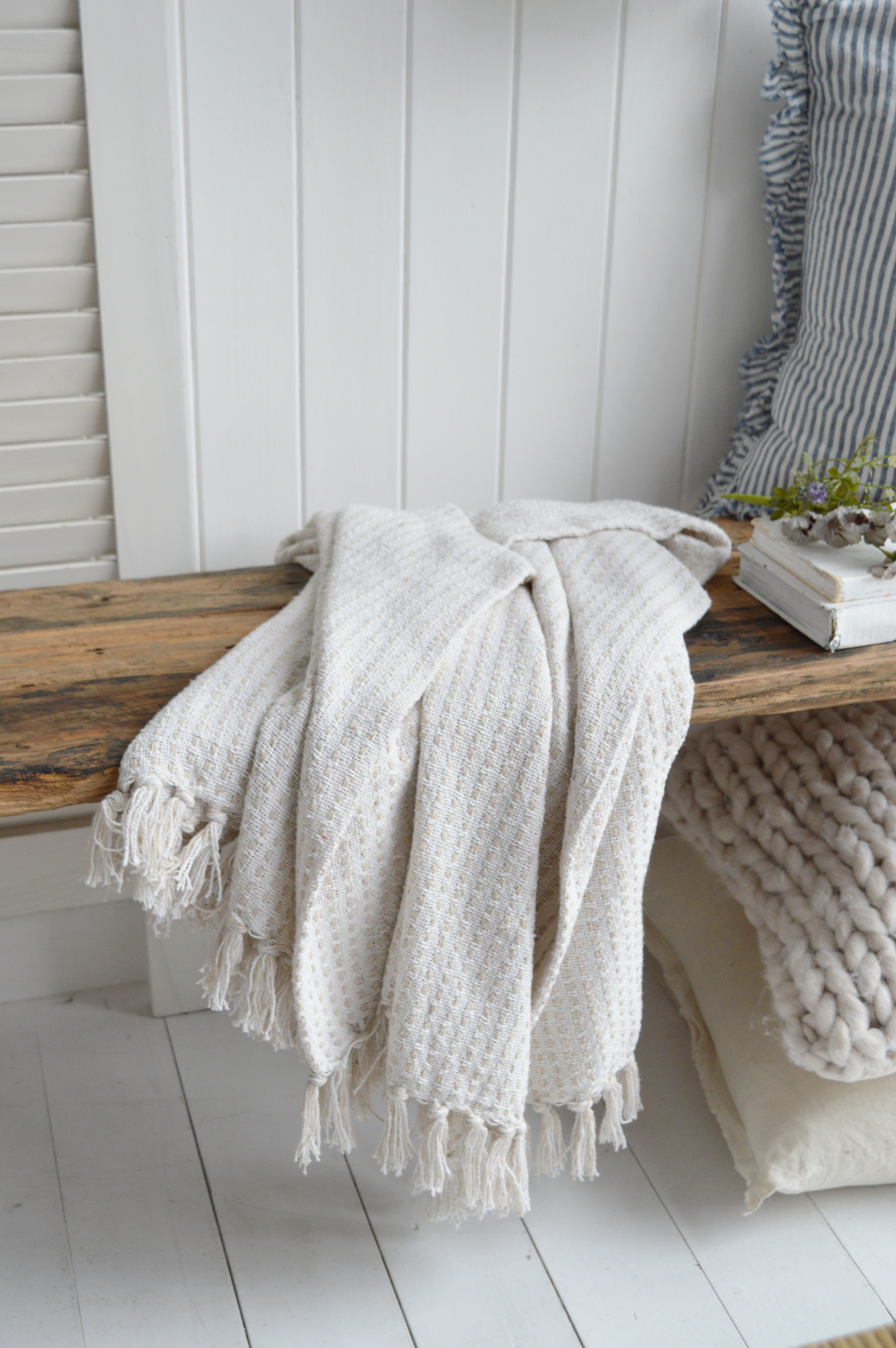 Beach-inspired dining room featuring driftwood table and woven chairs