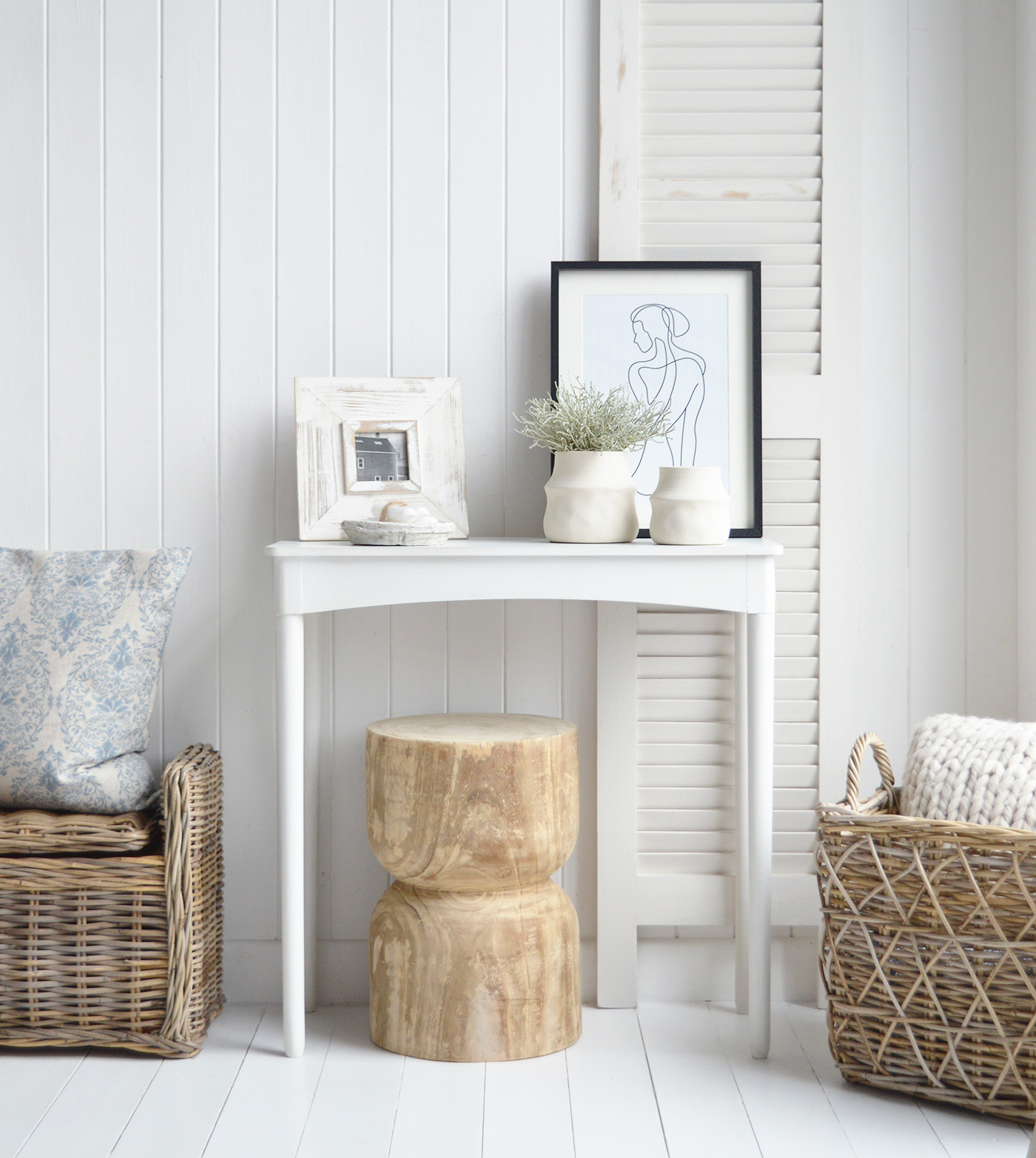 The Ascot hand carved wooden stool under the white Cape Ann console table inthe hallway