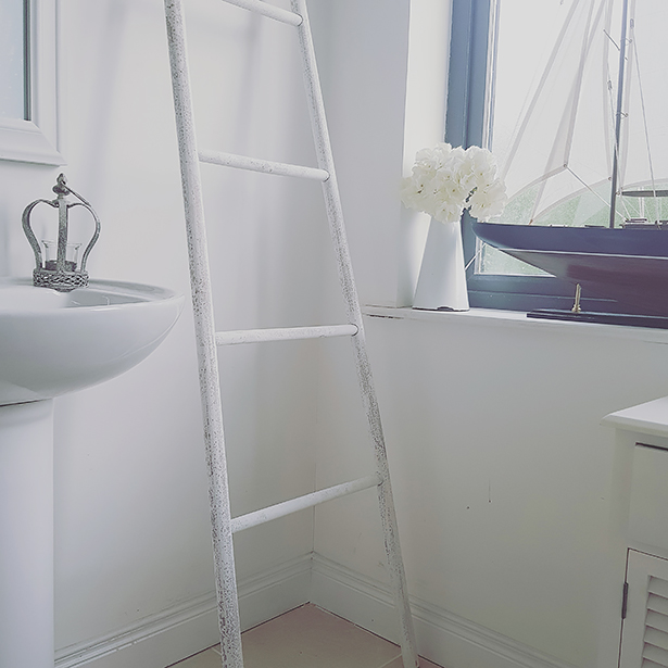 White towel ladder in a bathroom in a holiday home by the sea
