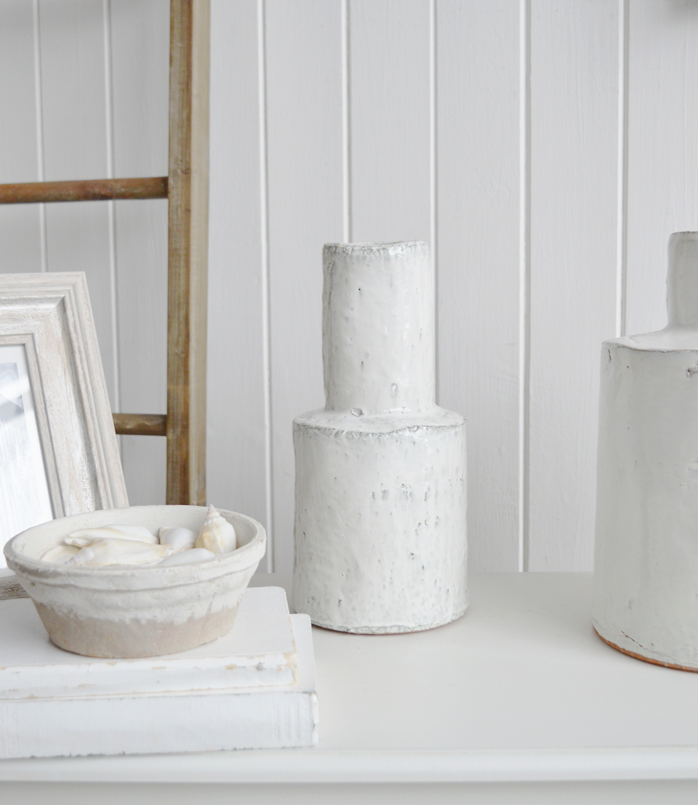 The Tall Betone Vase is a sculptural accent that brings texture and simplicity to coastal interiors.
