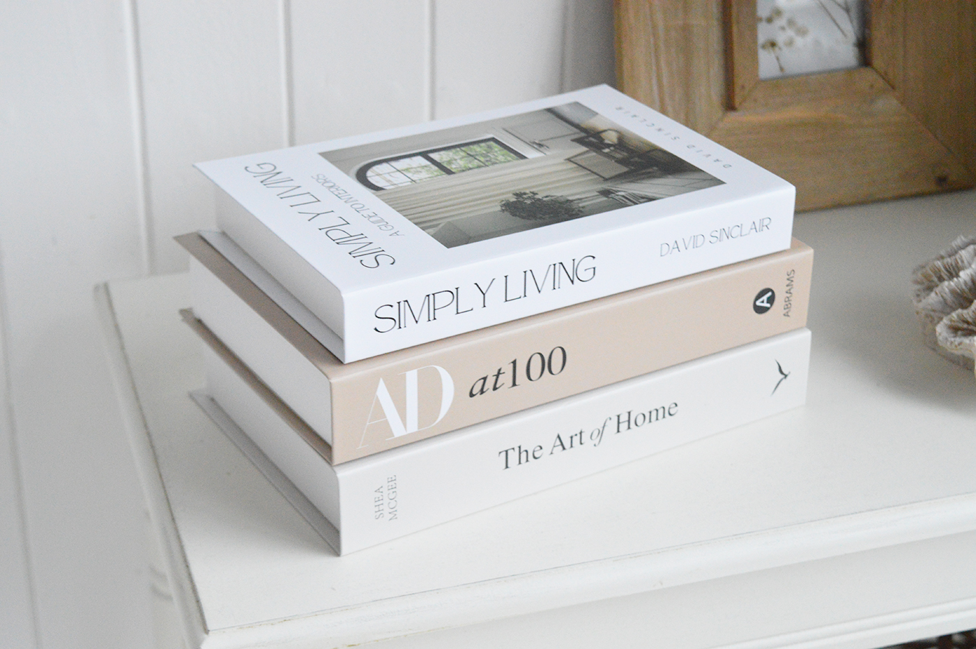 Shelf styling ideas using decorative cardboard books in soft beige and white tones.