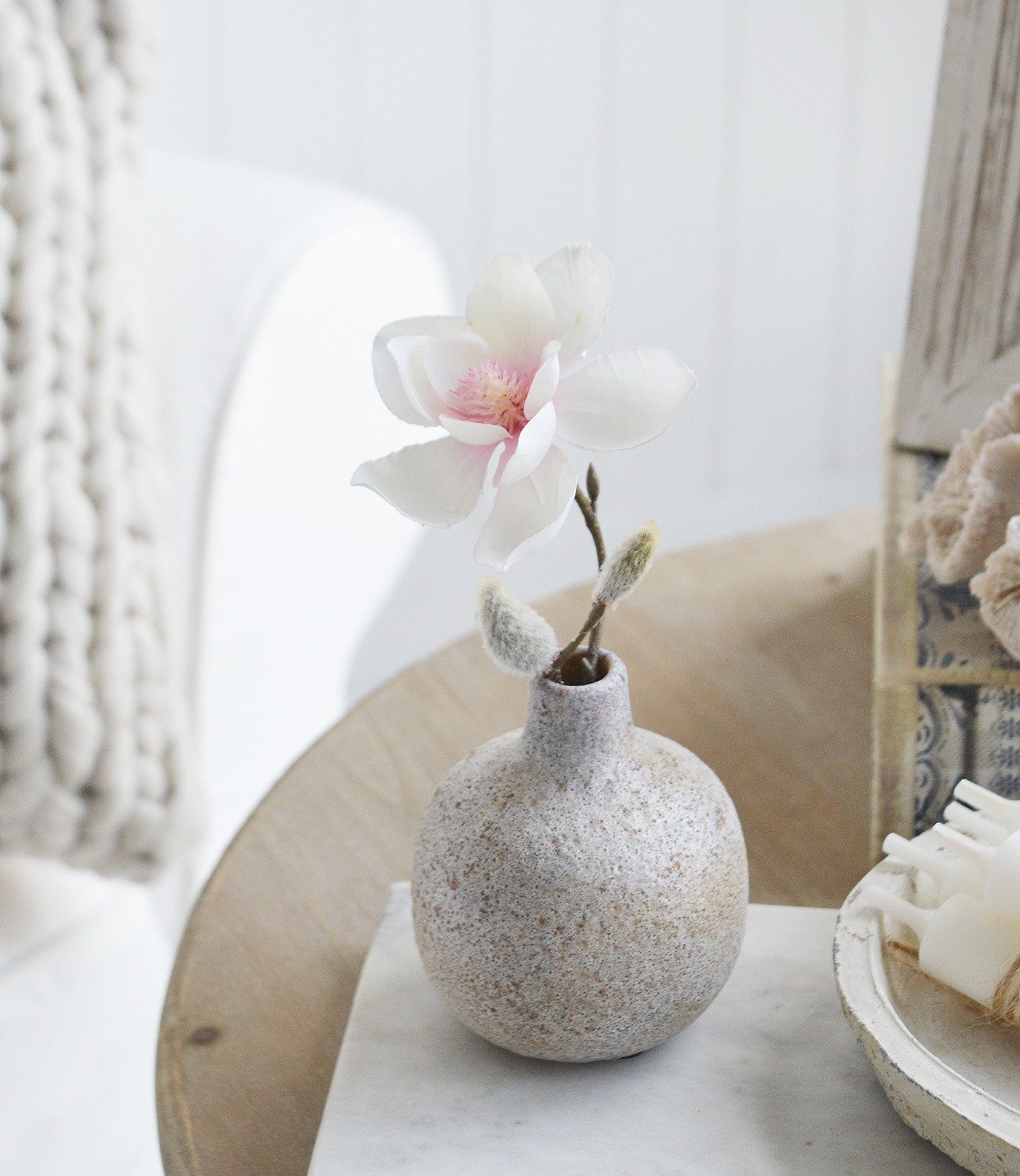 Terracotta coloured small Bradley pot with a stem of Magnolia