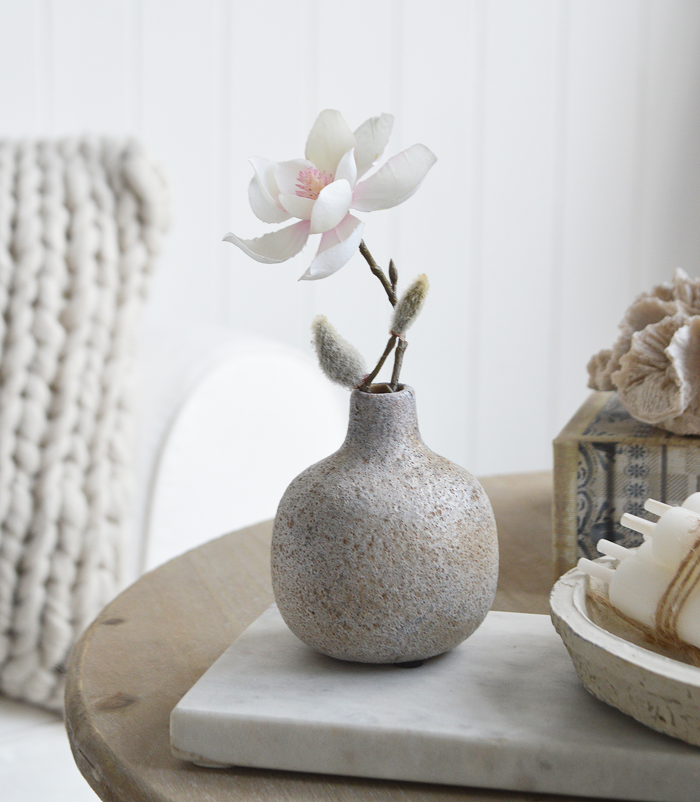 Terracotta coloured small Bradley pot with a stem of Magnolia