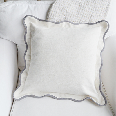 The Chatham Scallop Cushion blends coastal elegance and farmhouse simplicity, with soft cream linen and a refined grey scalloped edge.