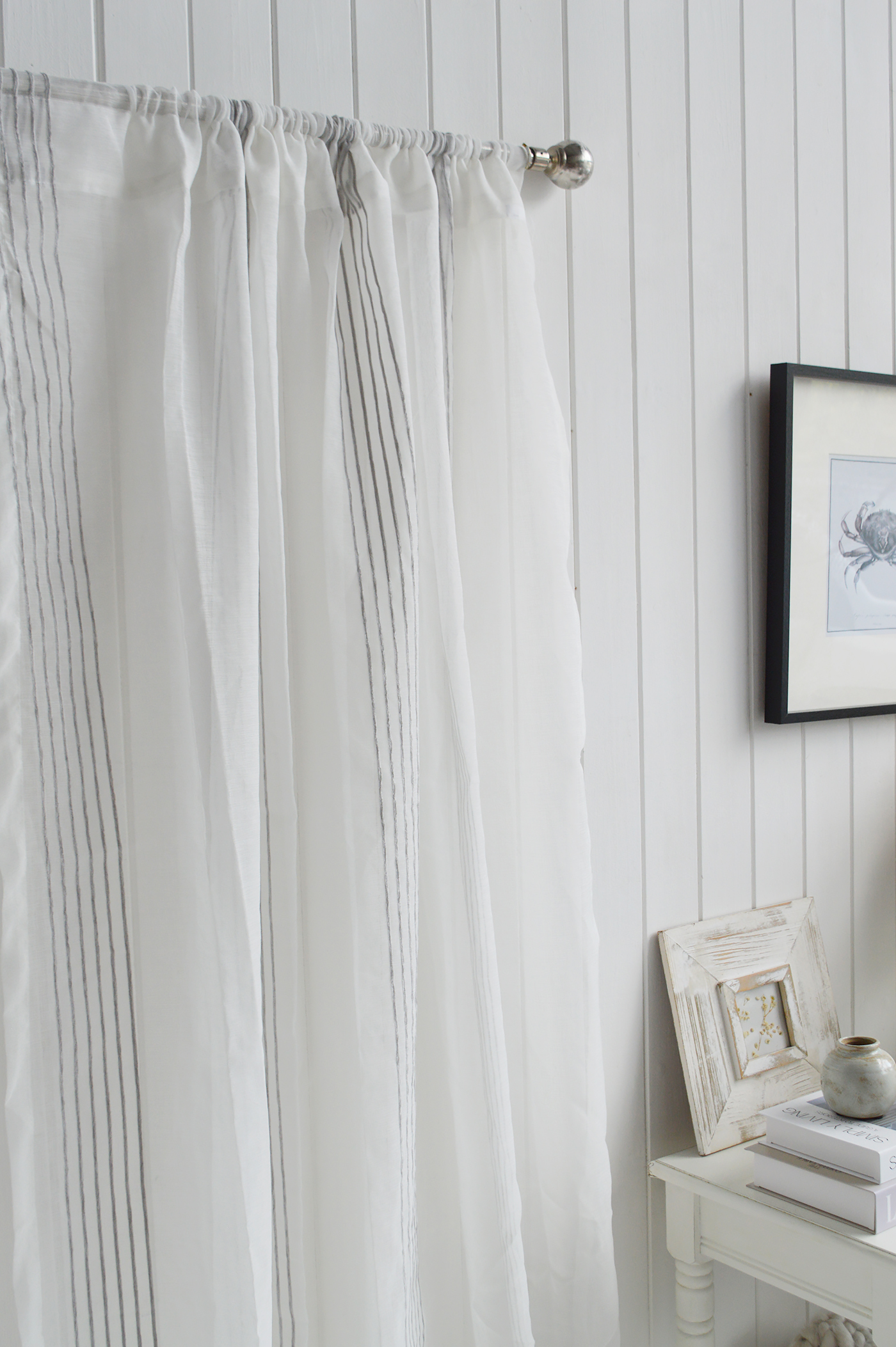 The Pebble Stripe Curtain adds effortless elegance to coastal interiors with its soft sheer voile and subtle woven stripes.