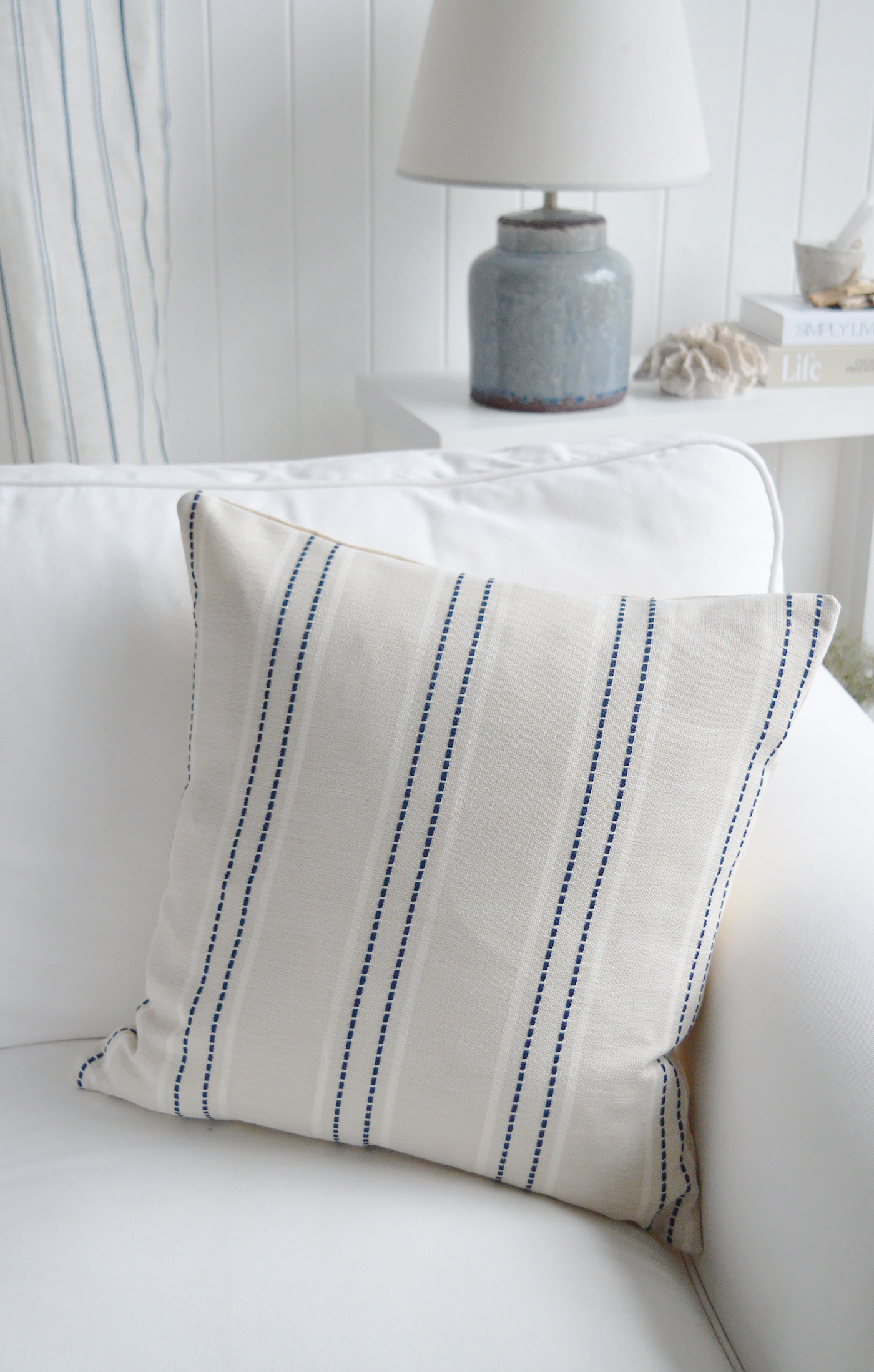 The Cotsmere Navy Stripe Cushion adds subtle contrast to neutral interiors with its timeless stripe design.