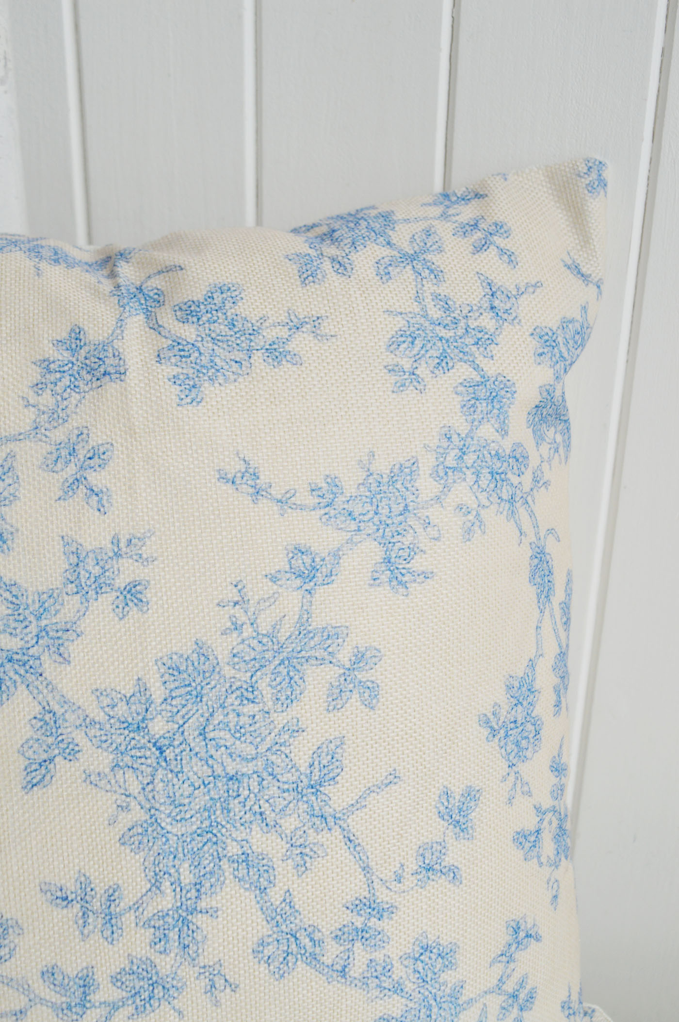 Delicate blue florals on a warm neutral fabric give the Haverhill cushion cover a soft vintage charm perfect for timeless Hamptons and country interiors.