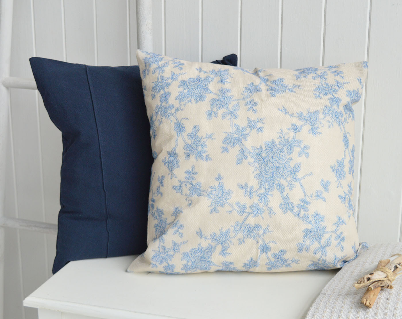 The soft blue floral Haverhill cushion paired with deep navy tones creates a timeless layered look inspired by elegant New England interiors.