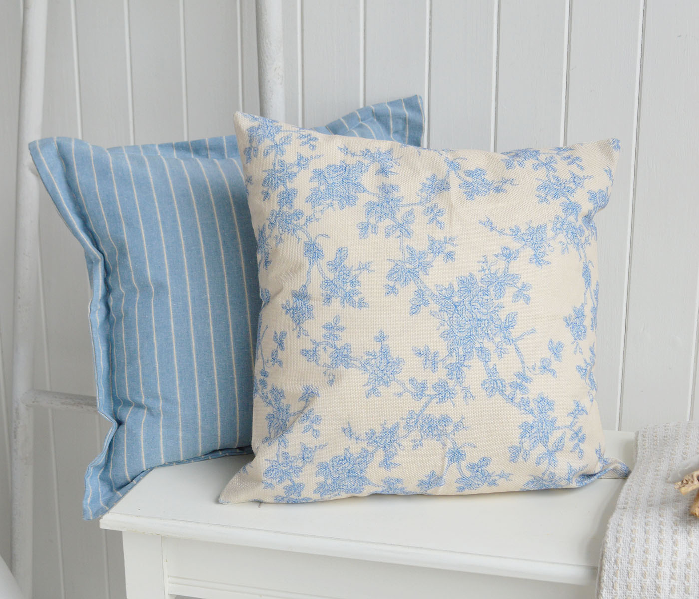 Soft florals paired with classic blue ticking stripes create a timeless New England look with a relaxed boutique coastal feel.