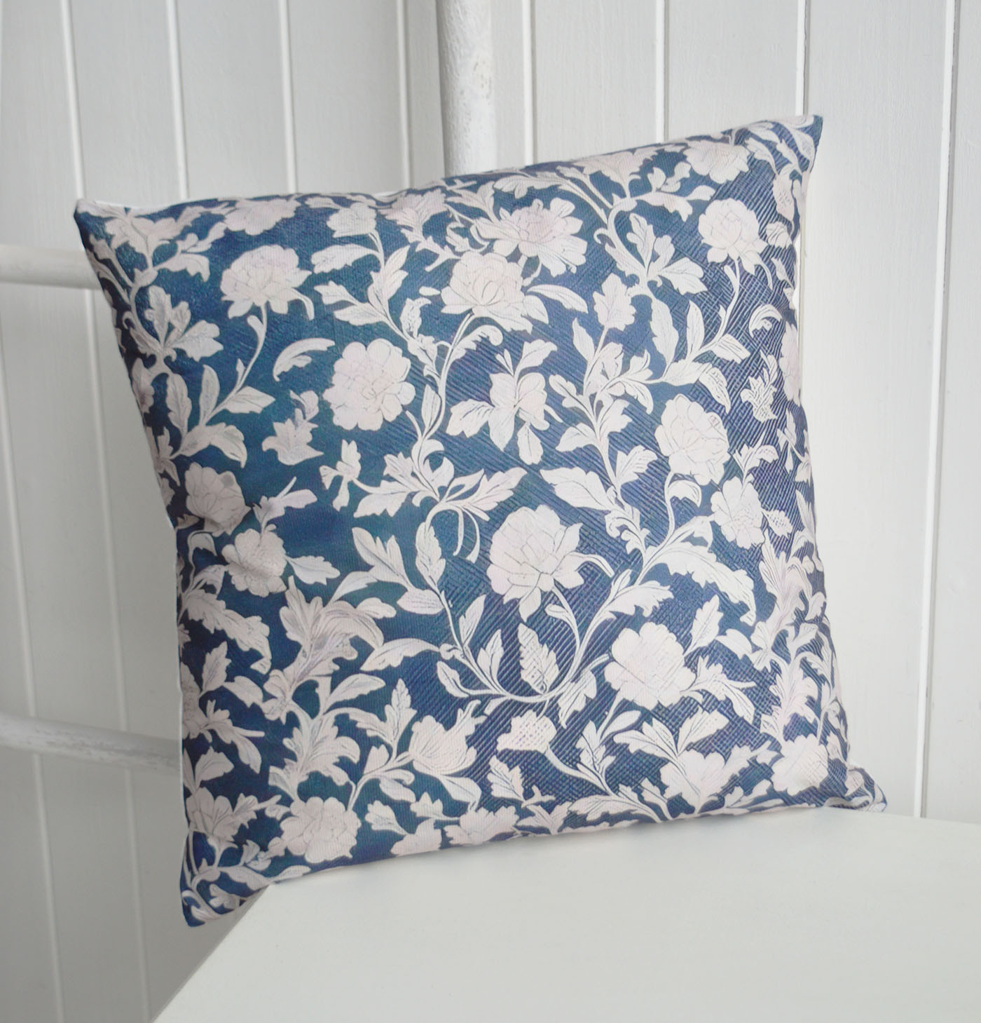 The Ashford cushion cover combines rich navy tones with elegant ivory florals, bringing timeless New England charm to coastal interiors, Hamptons homes and classic blue and white décor schemes.