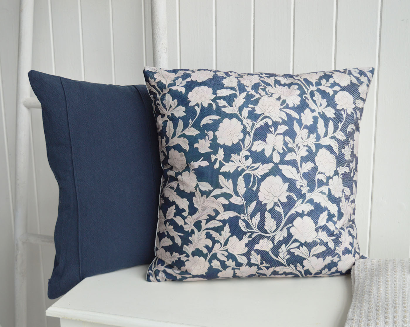 Layered navy tones and timeless ivory florals bring depth and elegance to coastal interiors, creating a refined New England and Hamptons inspired look.