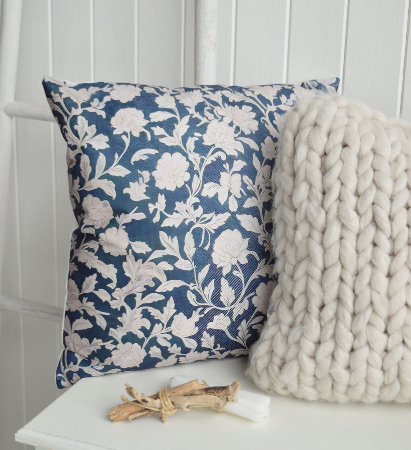 Rich navy florals, soft textures and cosy layered styling bring a timeless coastal elegance to New England interiors and relaxed Hamptons inspired homes.