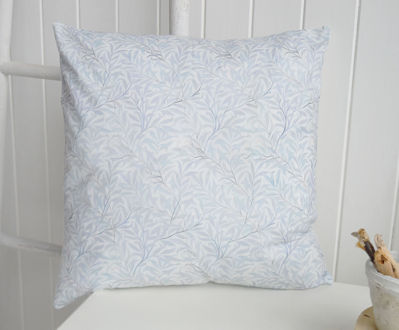 The Dalton Cushion Cover features a delicate pale blue botanical print inspired by timeless coastal interiors and relaxed Hamptons interiors, bringing a soft New England interiors feel to your home while pairing beautifully with luxury cushions, neutral linens and elegant coastal furniture.