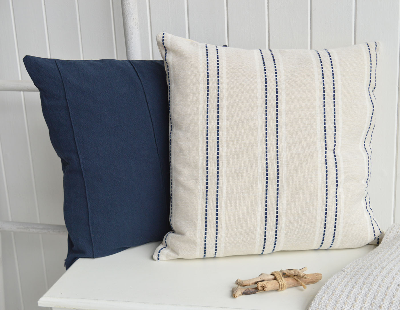 The Cotsmere Cushion Cover features timeless navy stripe detailing on a soft neutral fabric, bringing effortless Hamptons interiors style and classic New England interiors charm to coastal interiors and elegant beach house living spaces.